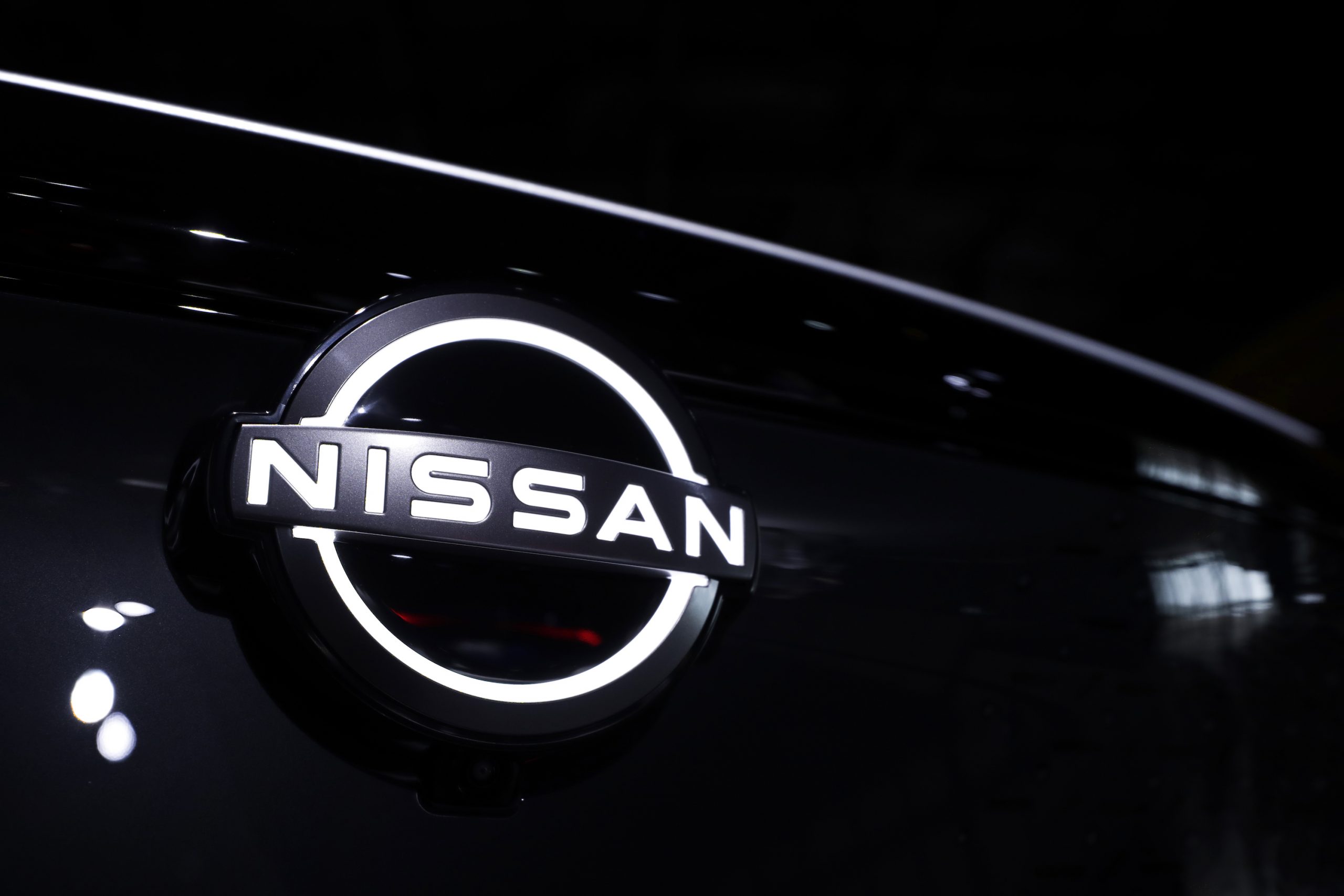 A backlit NIssan logo on a black grille