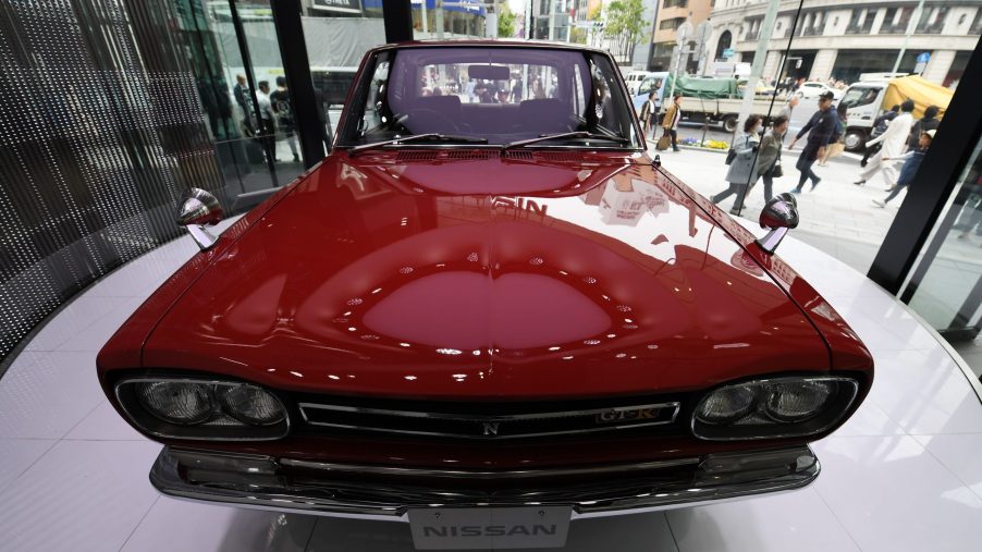 A red 1969 Nissan Skyline GT-R four door sedan on display