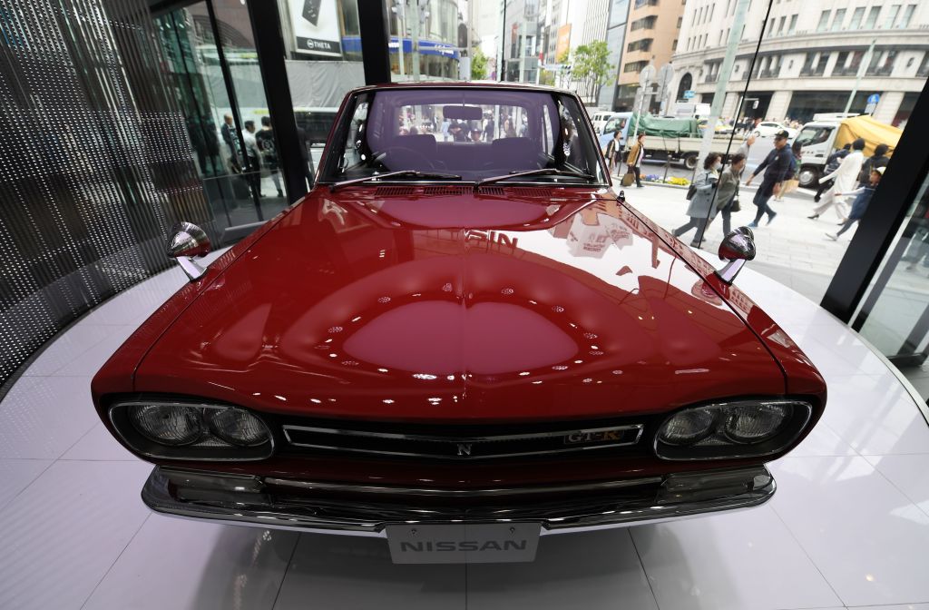 A red 1969 Nissan Skyline GT-R four door sedan on display