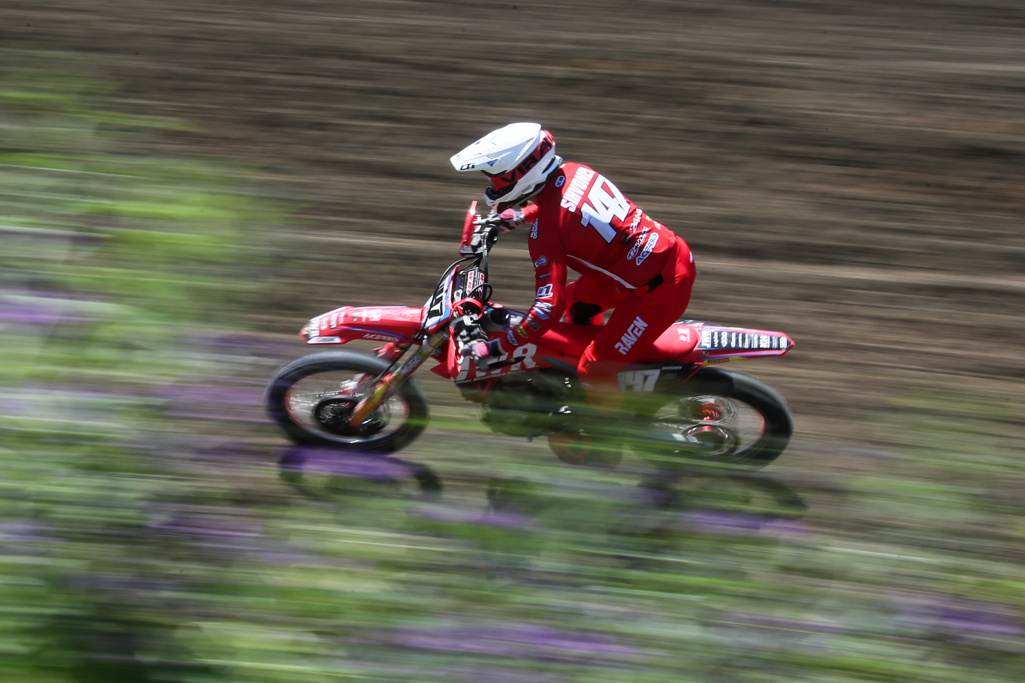 A motorcycle rider races in a 2021 motocross event