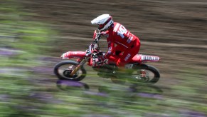 A motorcycle rider races in a 2021 motocross event