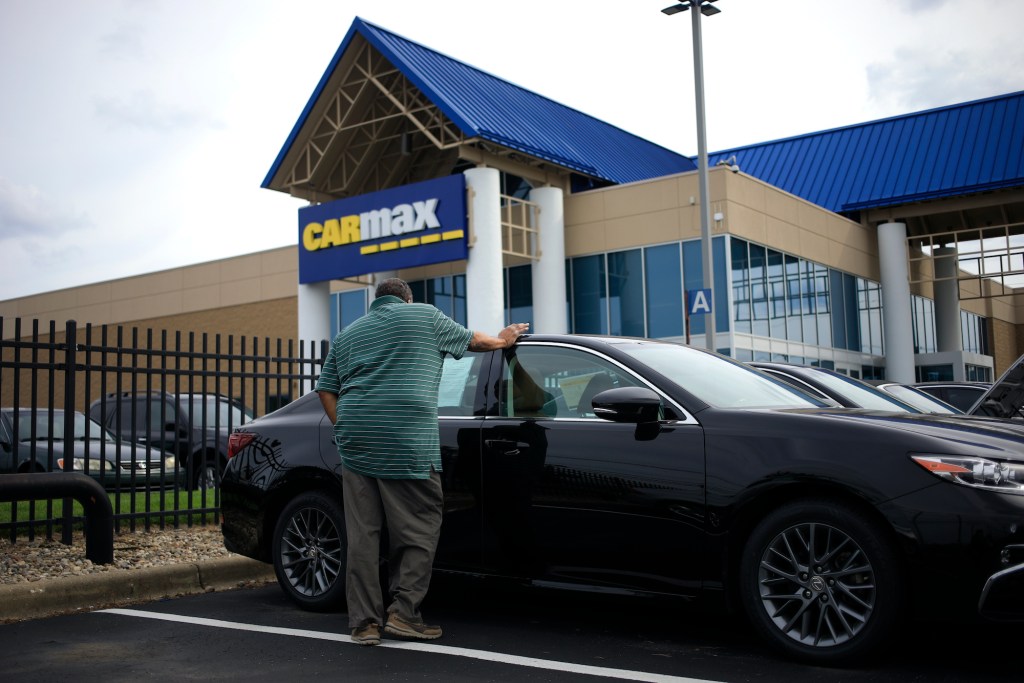 A customer shops for a used vehicle at a CarMax dealership