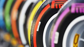 A row of Pirelli racing tires, each with a brightly colored stripe