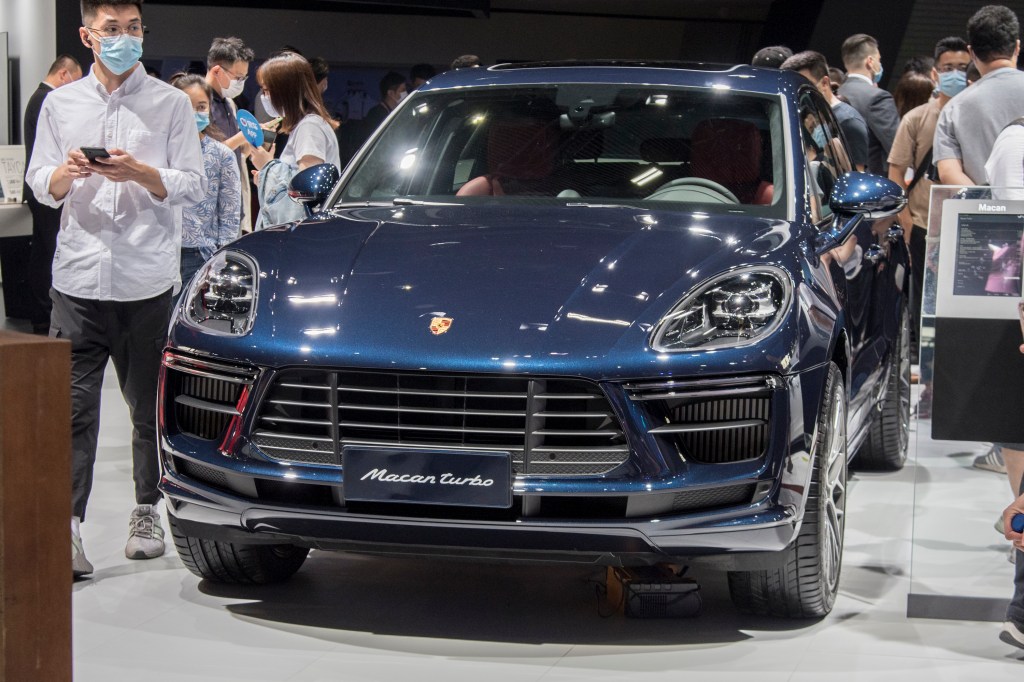 A blue Porsche Macan Turbo SUV on display