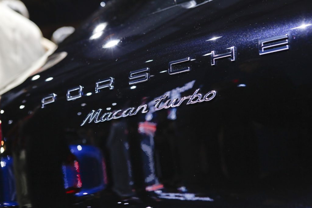 The chrome Porsche Macan Turbo badging on a dark blue SUV