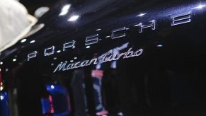 The chrome Porsche Macan Turbo badging on a dark blue SUV