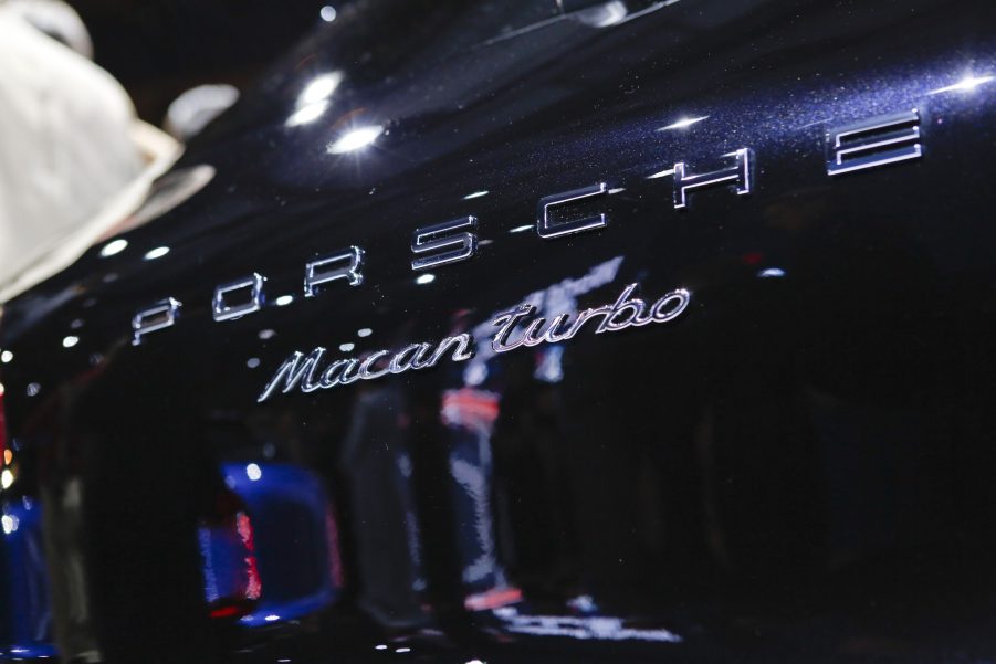 The chrome Porsche Macan Turbo badging on a dark blue SUV