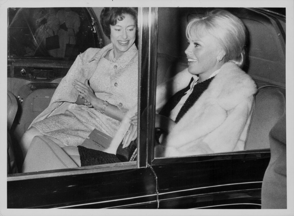 Princess Margaret and actor Britt Ekland in the back seat of a 1980 Rolls Royce Silver Wraith