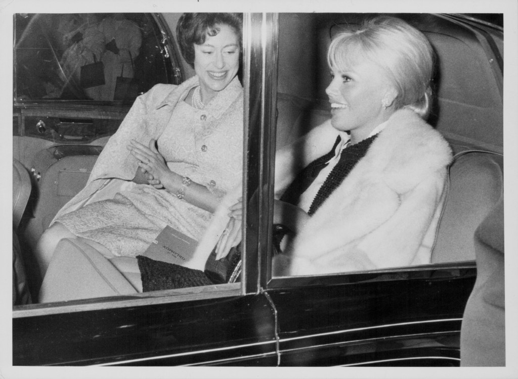 Princess Margaret and actor Britt Ekland in the back seat of a 1980 Rolls Royce Silver Wraith