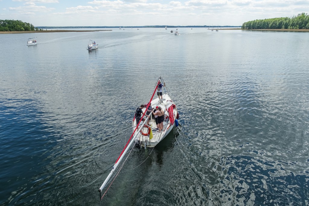 small sail bot heading out into the lake