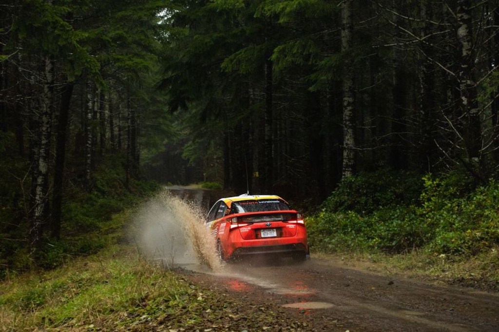 The rear end of the Toyota Prius rally car in the woods. This is easily one of the coolest hybrid cars in the world