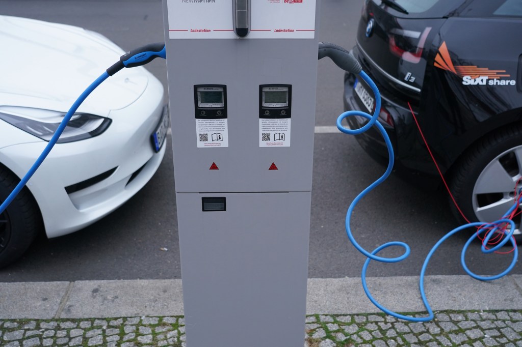 One black and one white EV charging 