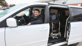 Teaching assistant Ryan Leworthy poses with his vehicle's wheelchair lift, paid for by an anonymous donor, in March 2016