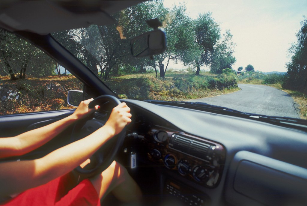 The woman driving an air-conditioned car, Island of Ibiza, Balearic Islands, Spain.