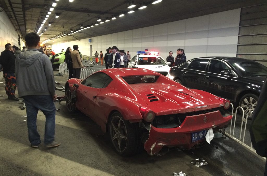 A wrecked exotic ferrari after crashing into lamborghini