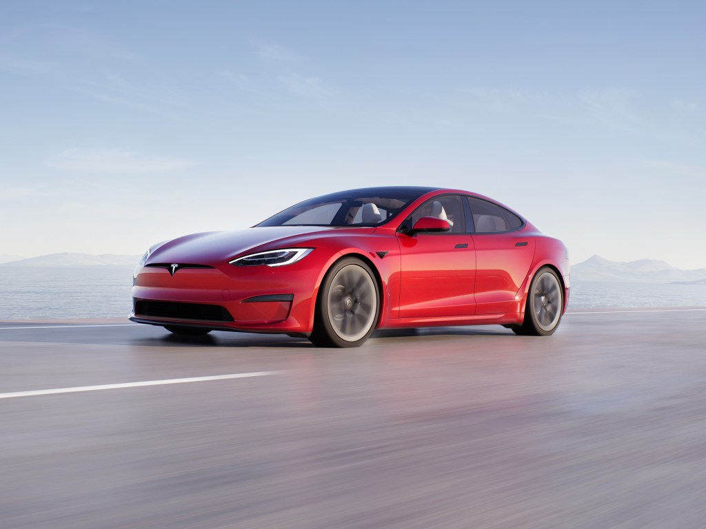 A red Tesla Model S racing down the road
