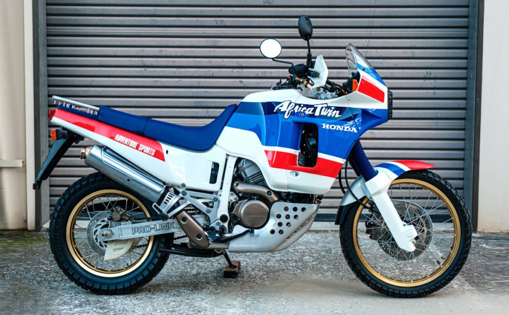 1989 vintage Honda Africa Twin parked in front of a garage 