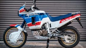 1989 vintage Honda Africa Twin parked in front of a garage