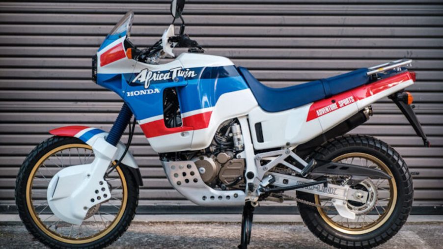 1989 vintage Honda Africa Twin parked in front of a garage