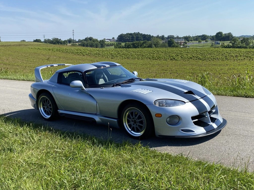A silver-with-black-stripes 1993 Dodge Hennessey Venom 600 RT/10 Aero on a country road