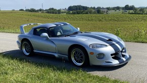 A silver-with-black-stripes 1993 Dodge Hennessey Venom 600 RT/10 Aero on a country road