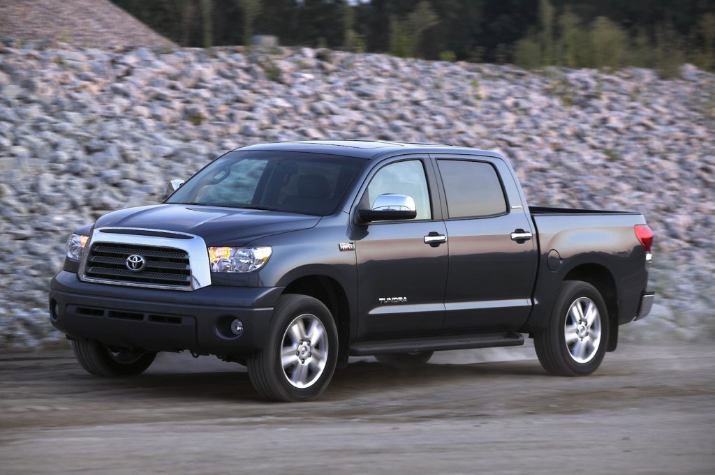 A black four-door 2005 Toyota Tundra parked next to a gravel hill, the 2005 Toyota Tundra is a used Toyota truck