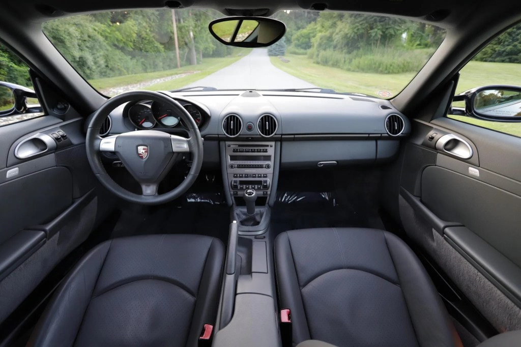 The gray-leather-upholstered seats and dashboard of a 2007 Porsche Cayman 5-Speed