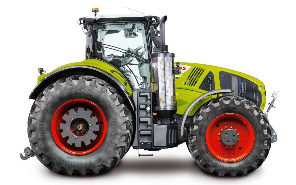 a light green Claas 960 Axiom tractor in a press photo against a white backdrop