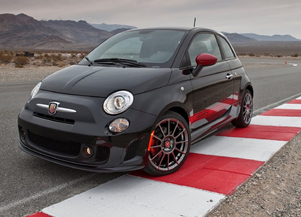 A black-and-red 2012 US-market Fiat 500 Abarth on a desert racetrack