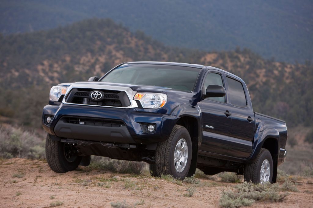 A navy 2013 Toyota Tacoma in the wilderness, the 2013 Toyota Tacoma is one of the best used compact trucks under $20,000