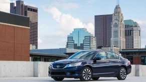 A 2015 Honda Accord Hybrid Touring parked in the city, the 2015 Honda Accord Hybrid Touring is the best used hybrid under $20,000