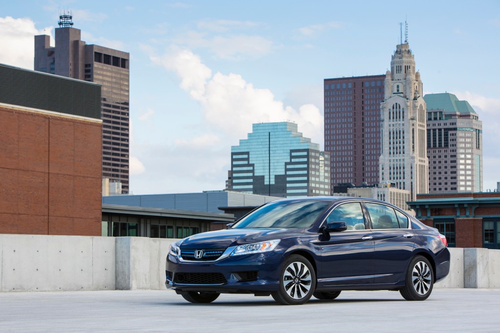 A 2015 Honda Accord Hybrid Touring parked in the city, the 2015 Honda Accord Hybrid Touring is the best used hybrid under $20,000
