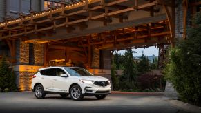 A white 2019 Acura RDX Advance SUV model parked under a bridge
