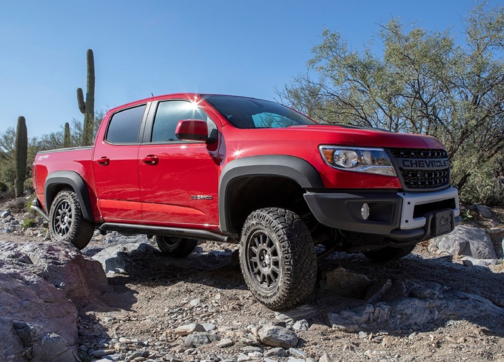 A red 2019 Chevrolet Colorado ZR2 Bison rock-crawling through the desert