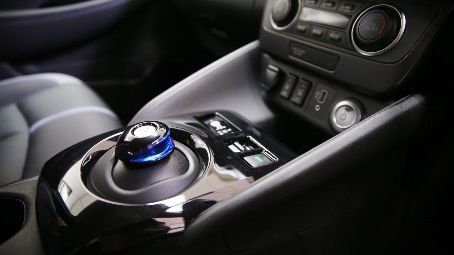 A 2019 Nissan Leaf's center console showing a gear shifter and other controls. The Leaf is vegan-friendly.