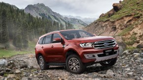 A red 2019 Ford Everest driving up a rocky trail
