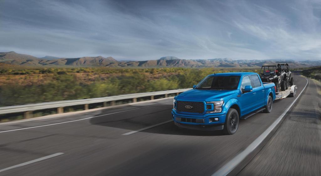 A blue 2020 F-150 XLT driving, the Ford F-150 is a used truck