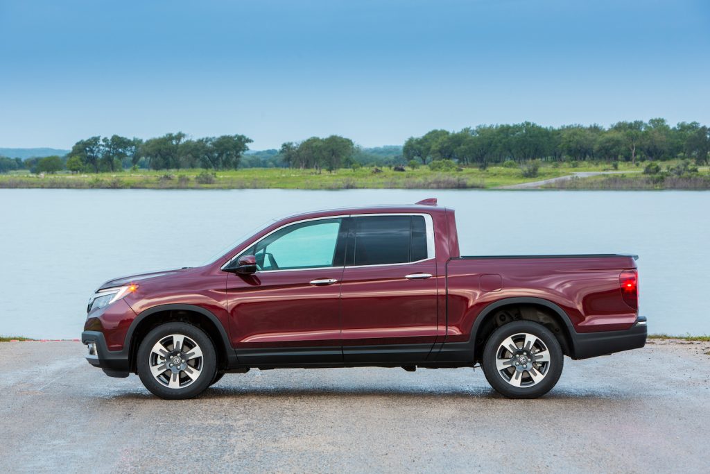 A red 2020 Honda Ridgeline parked by the water