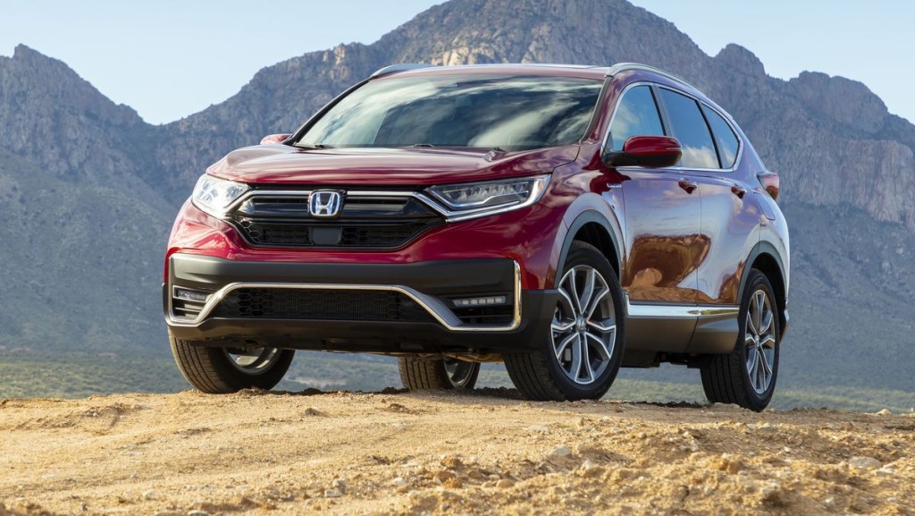 A red 2020 Honda CR-V parked in the dirt near mountains