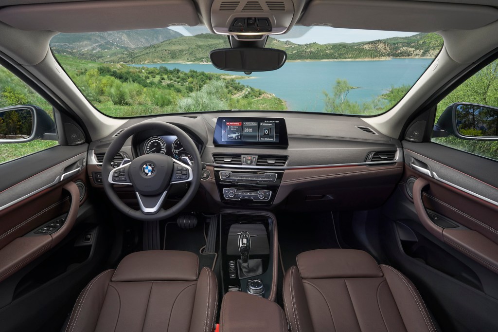 The interior of the 2021 BMW X1, featuring leather seating and a touchscreen display