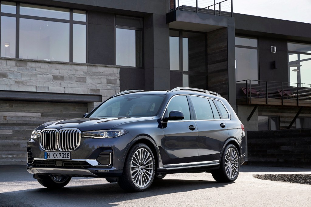 A 2021 BMW X7 parked in front of a house, the 2021 BMW X7 is a large luxury SUV