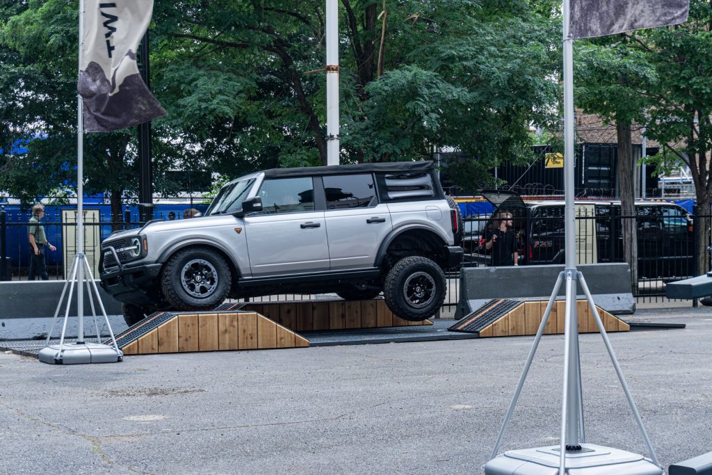 A silver 2021 Ford Bronco Badlands Sasquatch on a simulated off-road course