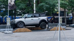 A silver 2021 Ford Bronco Badlands Sasquatch on a simulated off-road course