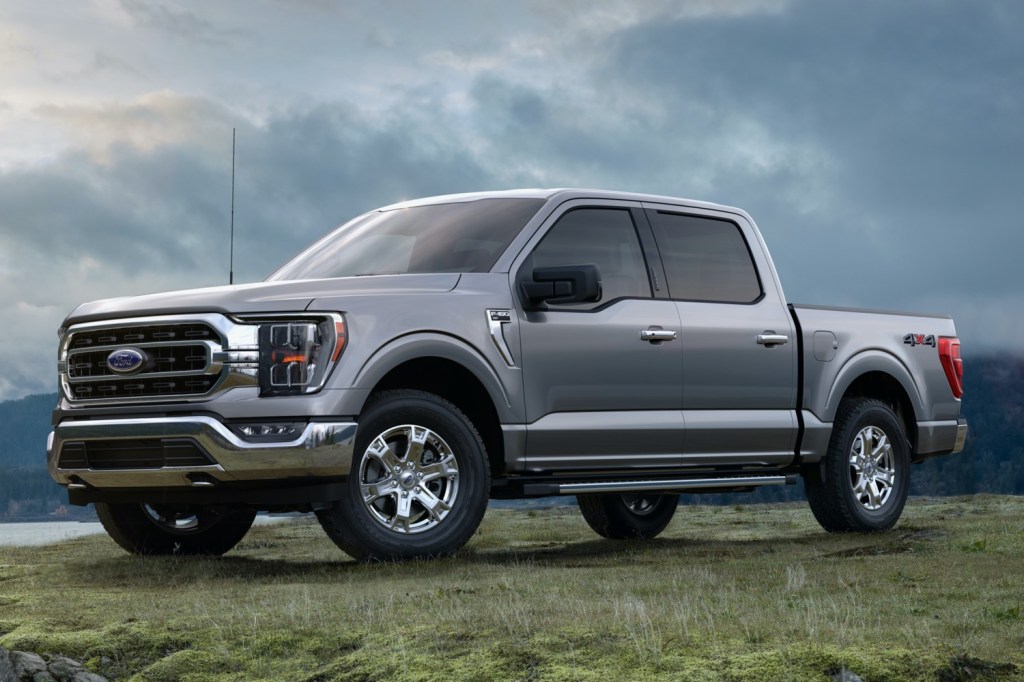 A grey 2021 Ford F-150 pickup truck model parked in grass on a cloudy day