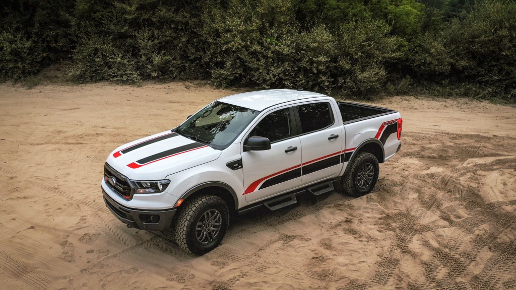 A white-with-red-and-black-stripes 2021 Ford Ranger XLT Tremor on a dusty trail