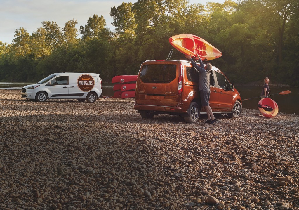 Two 2021 Ford Transit Connect vans next to a body of water