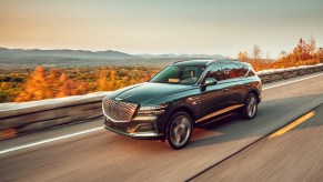 A black 2021 Genesis GV80 driving in the Hudson Valley, the 2021 Genesis GV80 is the best luxury SUV of 2021 according to KBB