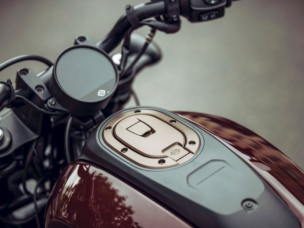 A close-up look at a maroon-and-black 2021 Harley-Davidson Sportster S's TFT dash and handlebars