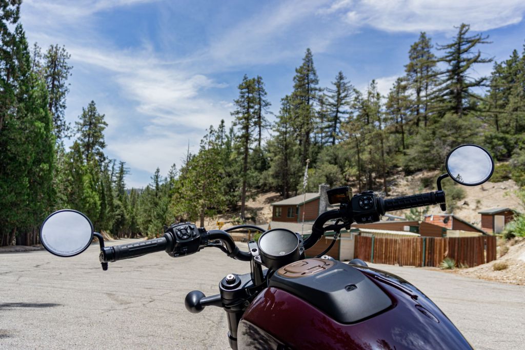 A maroon 2021 Harley-Davidson Sportster S handlebars with a view of the Angeles National Forest
