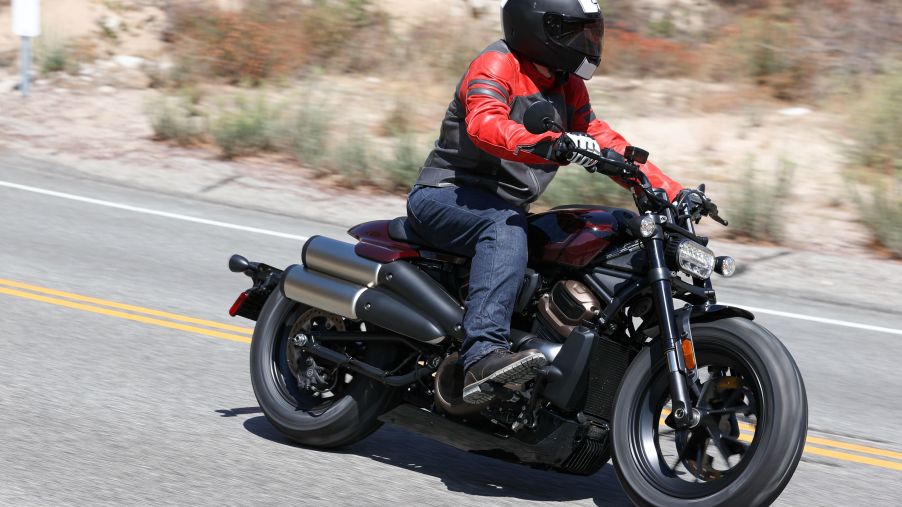 A side 3/4 view of the author riding a maroon 2021 Harley-Davidson Sportster S on the Angeles Crest Highway